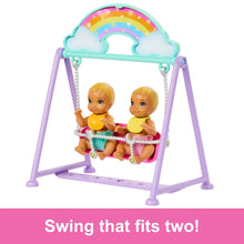 Purple swing set with twin baby dolls sitting on the cradle