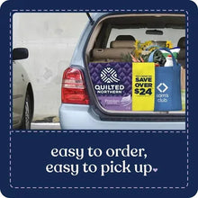 Quilted Northern Ultra Plush toilet paper packages in an open car trunk.