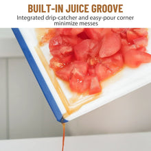 Plastic cutting board with blue border and corner juice groove, holding chopped tomatoes