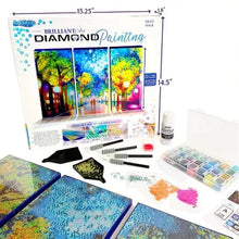 Diamond painting kit with triple canvas artwork, measuring guide, and accessories on table