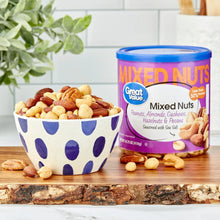 Mixed nuts container with blue lid and bowl of roasted salted nuts