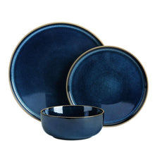 Midnight blue stoneware dinnerware set with two plates and a bowl, gold-trim edges