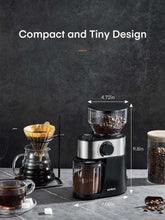 Compact electric coffee burr grinder with clear hopper and adjustable dial, silver and black