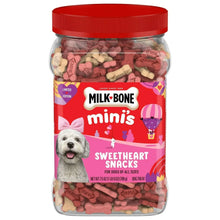 Dog treat canister with red lid, filled with pink and cream heart biscuits