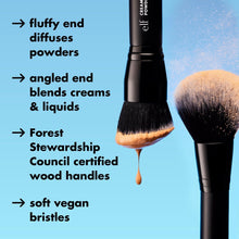 Face brush with angled gray bristles and black handle