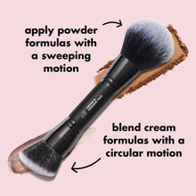 Angled face brush with sweeping gray bristles on matte black handle