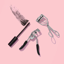 Metal eyelash curler with black silicone pad, clamp head and loop handles
