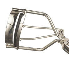 Close-up of metal eyelash curler clamp with black rubber pad and hinge bar
