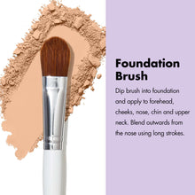 Foundation brush with dense brown bristles and silver ferrule on a white handle