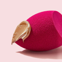 Pink teardrop face sponge with tan makeup smear on the edge