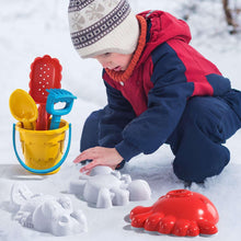 Toddler playing with sand and water table accessories, red dinosaur water spout
