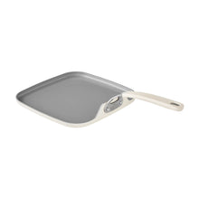 Nonstick grill pan with gray cooking surface and cream handle