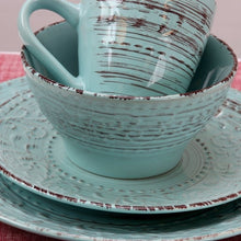 Turquoise ceramic bowl, mug, and plate with textured wave pattern