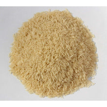 Uncooked basmati rice grains heap, light beige color