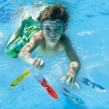 Kids pool dive torpedo toys floating near a swimmer in a swimming pool