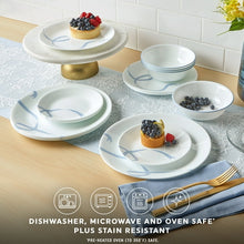 White glass dinnerware set with light blue ribbon vine design, plates and bowls