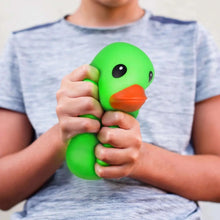 Green jumbo squishy duck toy, held and squeezed by hands, with cartoon eyes.