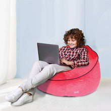 Red bean bag chair for kids with Spider-themed face, child sitting with laptop