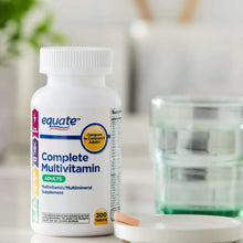 Adult complete multivitamin supplement bottle with open white cap