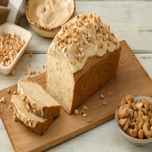 Lightly salted whole cashews with bread slices on a wooden cutting board