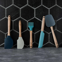 Five silicone cooking utensils with beechwood handles, blue and teal spatulas plus brush