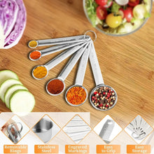 Stainless measuring spoon set with engraved handles and spice-filled spoon bowls