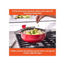 Red caldero pot with glass lid and steam vent, chrome handles