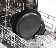Round black ceramic nonstick skillet with flared rim, inside dishwasher rack