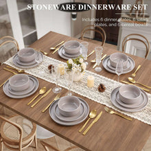 Ceramic dinnerware set on table: plates, salad plates, bowls, speckled