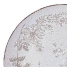 Floral stoneware plate with speckled white glaze and gray botanical design on rim