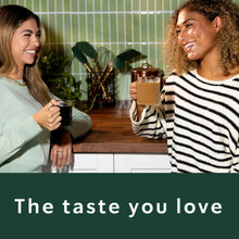 Ground coffee drinks in clear glasses, held by two people