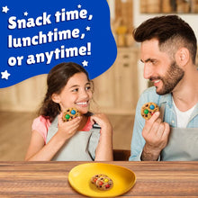 Father and child holding Keebler cookies with M&M’s candy pieces
