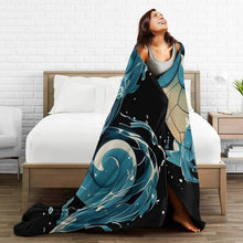 Large flannel throw blanket with teal turtle character and wave splash design