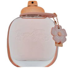Coach floral eau de parfum bottle front view, blush leather-style cap and flower charm