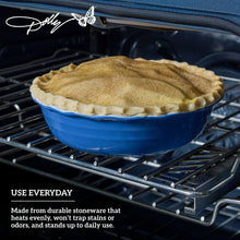 Blue ceramic pie dish with a baked pie inside, on an oven rack