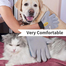 Pet grooming glove in gray mesh with black wrist strap and yellow pull tab