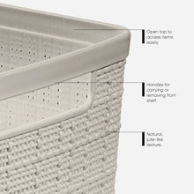 Beige woven plastic basket with open rim and built-in carry handles