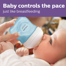 Blue Philips Avent baby bottle held by caregiver for feeding a baby