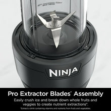 Personal blender blade assembly inside clear jar on dark blender base