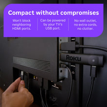 Roku streaming stick plugged into a TV with HDMI and cable connections visible