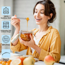 Stainless measuring spoon with smooth edges shown with a glass jar of ingredients
