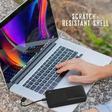 Black power bank connected to a laptop with a USB charging cable