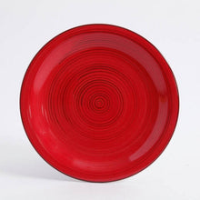 Red ceramic dinner plate with concentric ring pattern and glossy finish