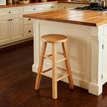 Natural wood backless counter stool with round seat, angled legs, and lower brace bar