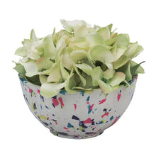 Speckled white clay planter bowl with green artificial flowers