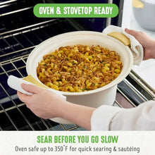 Cream slow cooker with removable pot held on oven rack; food ready to cook