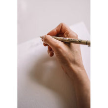 Fineliner pen held in hand with a fine drawing tip