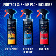 Three spray bottles standing upright with red-and-black trigger nozzles for detailing