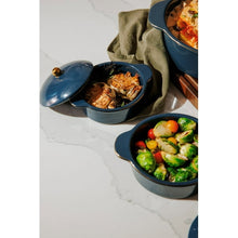 Blue ceramic casserole set with one open pot and covered dishes, gold knob lids