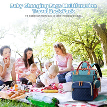 Baby travel diaper bag backpack with quilted front, top handles, and side insulated pocket.